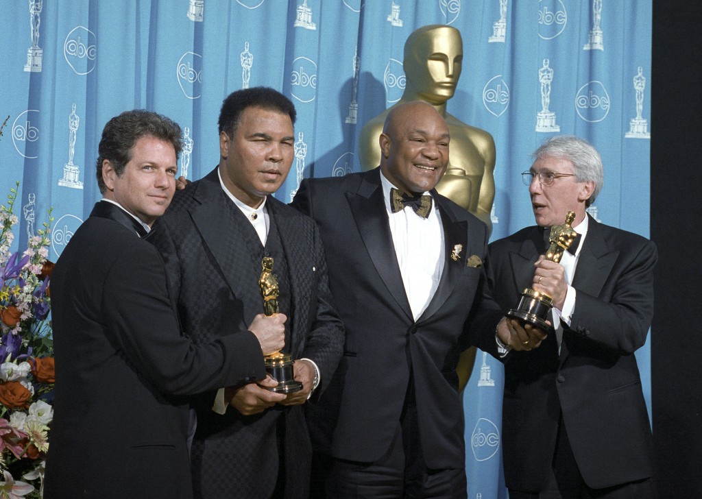 Muhammad Ali, George Foreman y Leon Gast (director del documental) posan con el Oscar conseguido en 1996